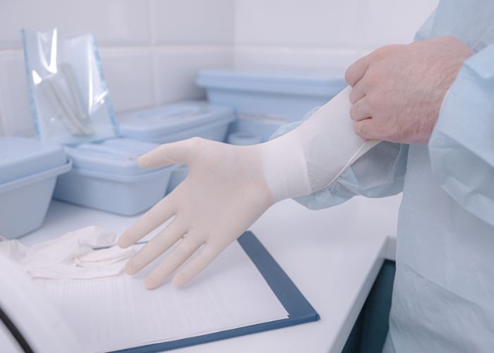 hospital staff wearing white gloves